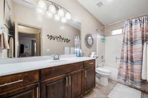 Full bathroom featuring shower / bathtub combination with curtain, vanity, and light tile patterned flooring