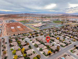 Aerial overview of property's location featuring a mountain backdrop and nearby suburban area