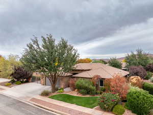 View of front of property featuring concrete driveway and stucco siding