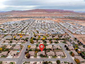 Aerial view of property's location with nearby suburban area and mountains