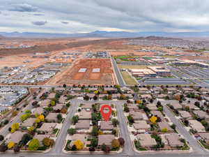 Aerial view of property's location featuring a mountainous background and nearby suburban area