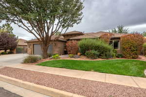 View of front of house featuring stucco siding, concrete driveway, and a tile roof