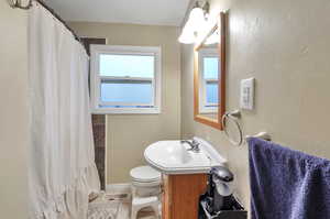 Bathroom with tile patterned floors, vanity, and toilet