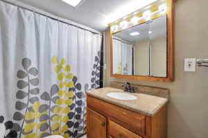 Bathroom featuring vanity and curtained shower