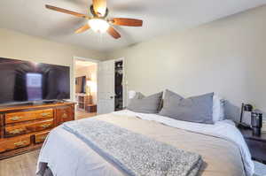 Bedroom featuring ceiling fan, a closet, and light hardwood / wood-style flooring