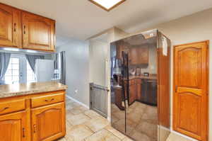 Kitchen with black fridge with ice dispenser and french doors