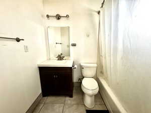 Full bathroom featuring tile patterned flooring, vanity, shower / bath combination with curtain, and toilet