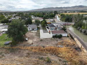 Birds eye view of property featuring a water and mountain view