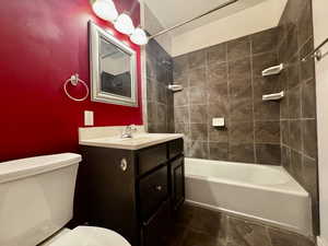 Full bathroom featuring vanity, toilet, and tiled shower / bath