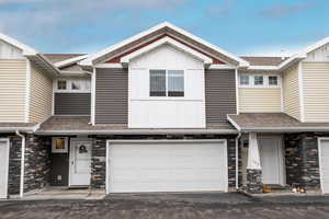 Townhome / multi-family property featuring a garage