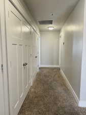 Hallway featuring carpet flooring