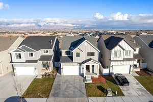 View of front of property with a mountain view and a garage