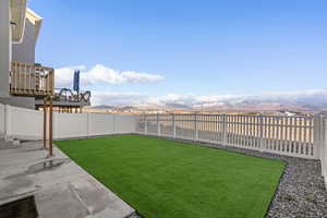 View of yard featuring a deck with mountain view