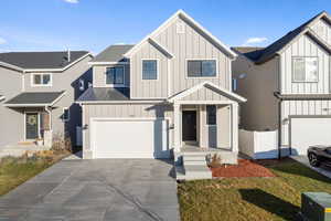 View of front of house with a front yard and a garage