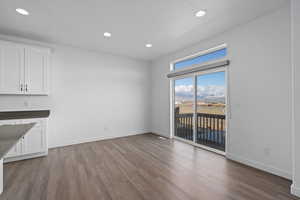 Dining area featuring a textured ceiling and hardwood / wood-style flooring