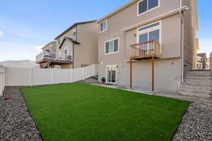 Rear view of house with a lawn