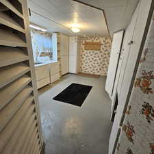 Interior space with concrete flooring and washing machine and clothes dryer