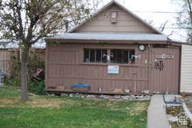 Exterior space with an outdoor structure and a lawn