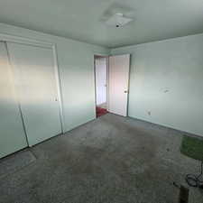 Unfurnished bedroom featuring carpet floors and a closet