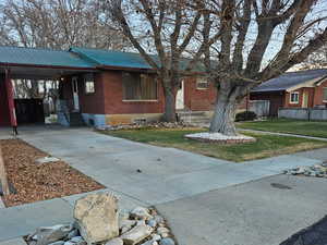 View of front of house with a front lawn and a carport