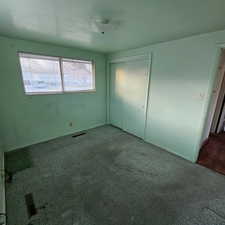 Unfurnished bedroom with carpet flooring and a closet