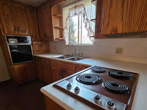 Kitchen with black appliances and sink