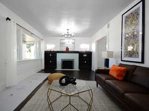 Living room featuring wood-type flooring and a chandelier