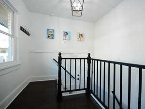 Staircase featuring a chandelier and hardwood / wood-style flooring