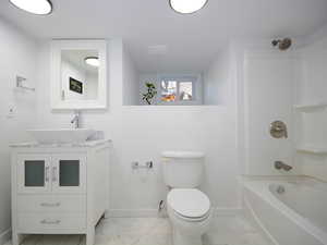 Full bathroom with vanity, toilet, and shower / washtub combination