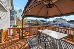 Wooden terrace featuring a mountain view and a gazebo