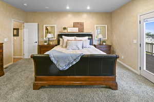 Carpeted bedroom featuring access to outside