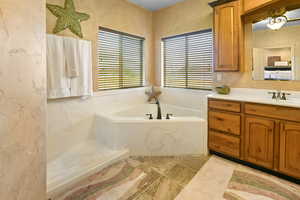 Bathroom featuring a bathing tub and vanity