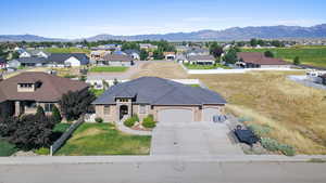 View of front of property featuring a mountain view, solar panels, and a garage