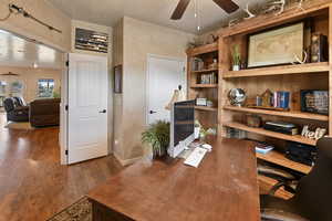 Office featuring ceiling fan, french doors, and dark hardwood / wood-style floors