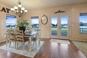 Dining area with dark hardwood / wood-style floors and plenty of natural light