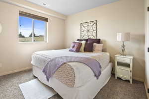 Bedroom featuring dark carpet