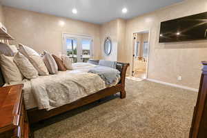 Bedroom featuring carpet flooring, access to exterior, ensuite bathroom, and french doors