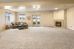 Living room featuring carpet and plenty of natural light