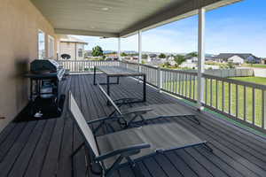 Wooden deck with grilling area and a yard