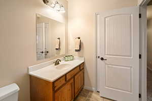 Bathroom with tile patterned flooring, vanity, and toilet