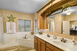 Bathroom featuring tile patterned flooring, vanity, and plus walk in shower