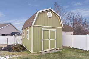 View of outdoor structure with a lawn