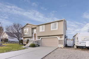 Raised ranch with a garage and a front lawn