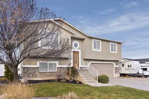 Split foyer home featuring a garage