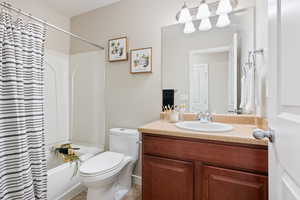 Full bathroom featuring vanity, toilet, and shower / tub combo