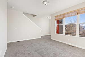 Carpeted empty room with a healthy amount of sunlight