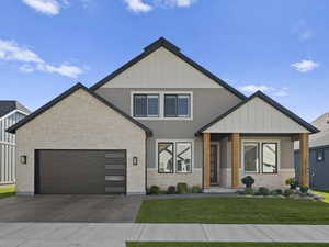 View of front of home featuring a front yard and a garage