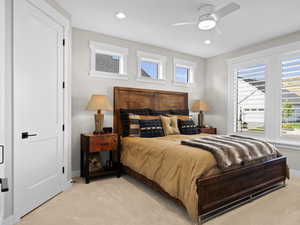 Ensuite Secondary Bedroom Carpeted bedroom featuring ceiling fan