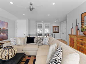 Living room with ceiling fan and light hardwood floors