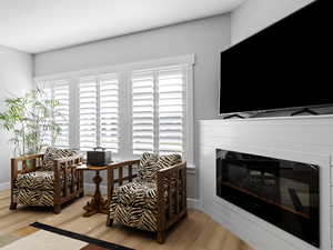 Living area with built in fireplace and  light hardwood floors.